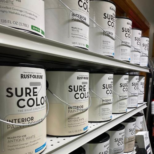 Rows of white paint cans labeled 